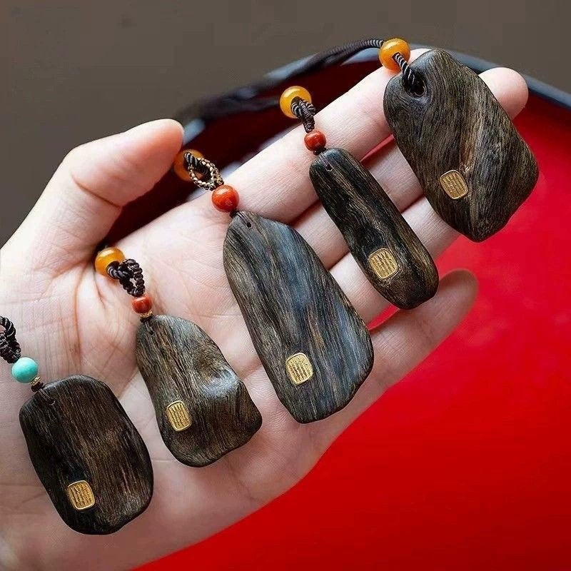Top-down arrangement of Agarwood Pendant (photo 6 of 9) for quality comparison