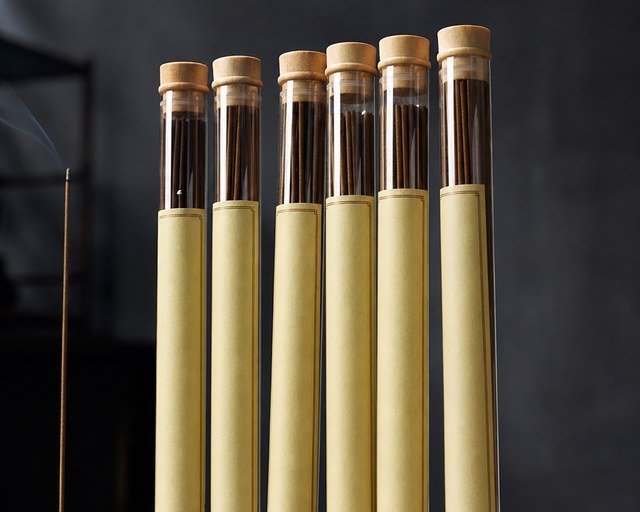 Sealed retail tubes of agarwood incense with wooden caps and labels — packaged units exempt under CITES annotation #14